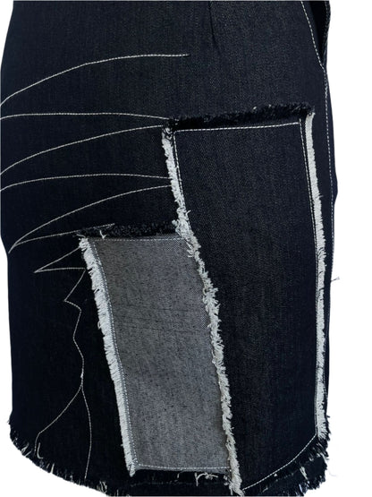Black fabric with white stitching on a white background
