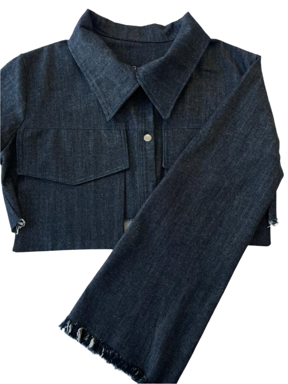 Dark blue denim jacket with frayed hem on a white background