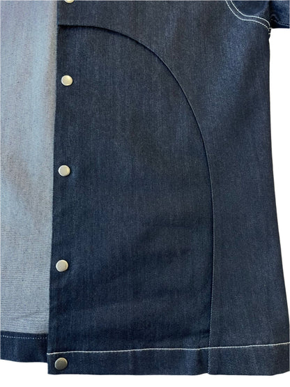 Close-up of a dark denim jacket with gold press studs on a white background
