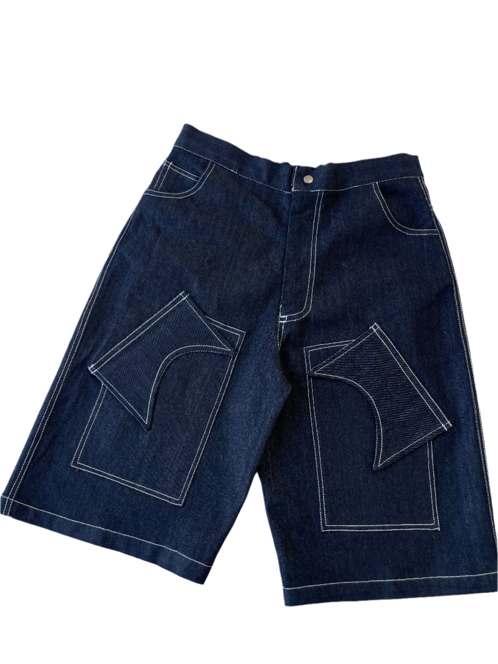Pair of dark blue jeans with white stitching on a light gray background